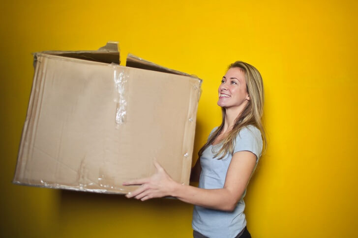 Woman relocating and holding a box