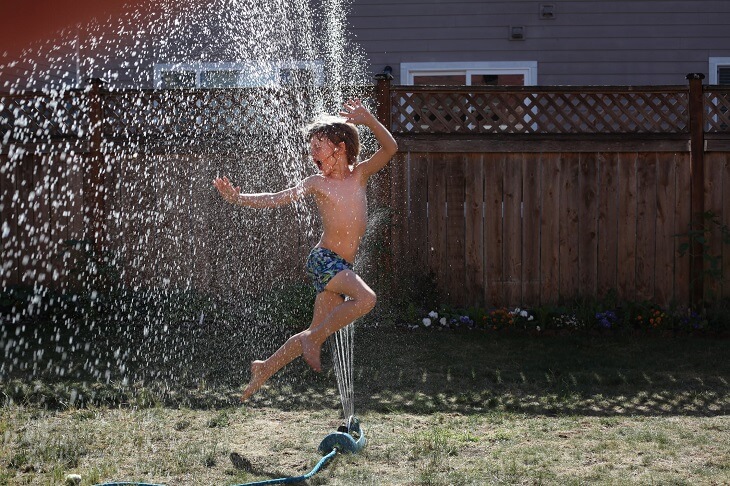 playing in sprinkler