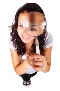 Woman holding a magnifying glass