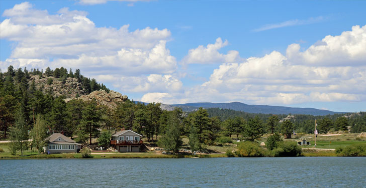 red feather lakes colorado cabins mountains blue skies and white clouds